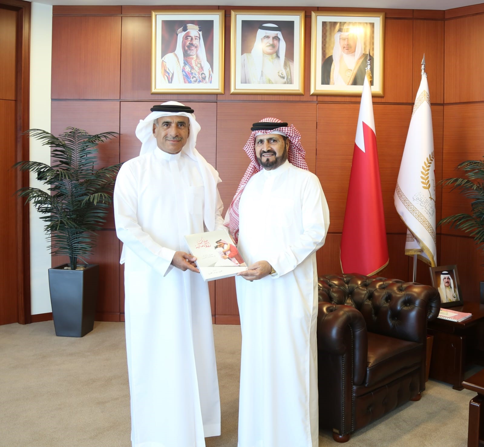 The president receives a copy of the book "The King of Humanity: Human Rights in Bahrain."